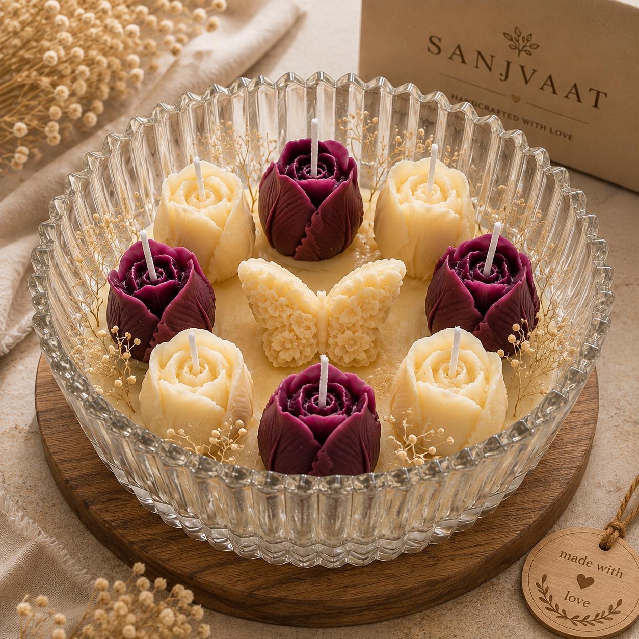 Rose and butterfly candles arranged in a cut-glass bowl