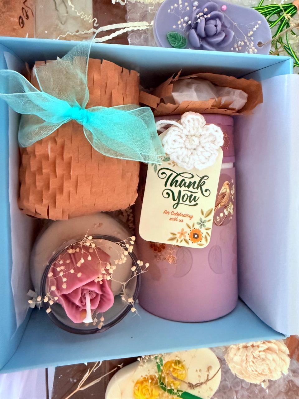 Sanjvaat gift box containing a rose candle, a pink vessel and a thank-you tag