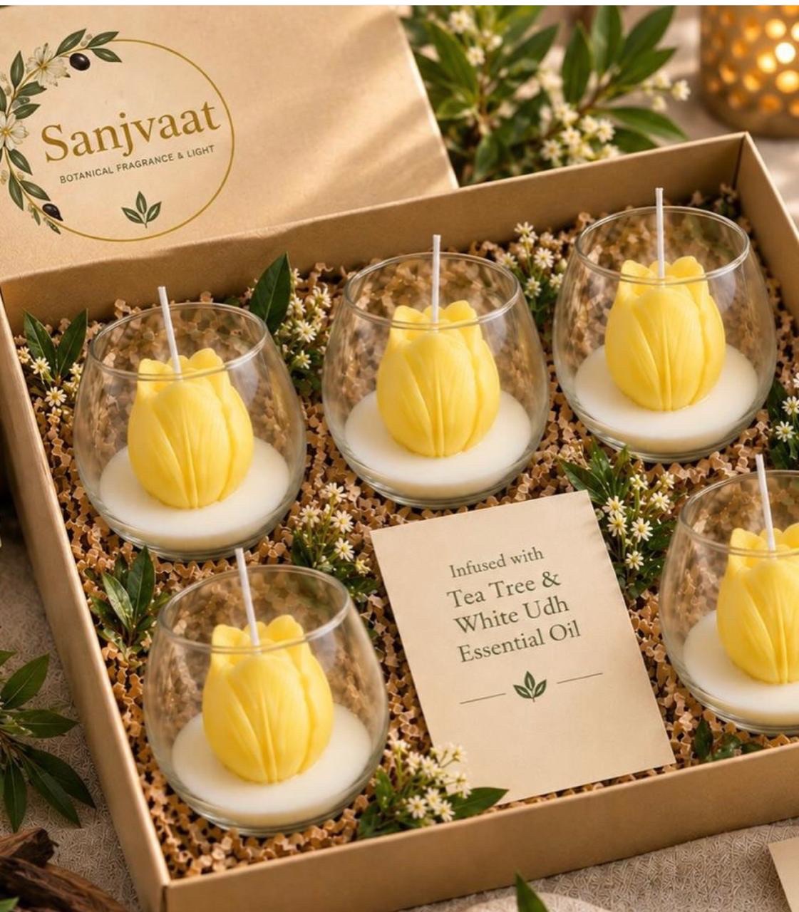 Yellow flower candles in clear glass vessels inside a Sanjvaat gift box
